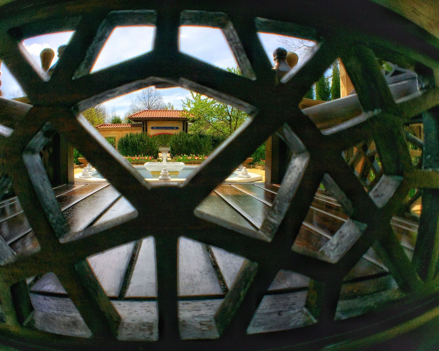 Camera framed through a decorative bench overlooking a garden at the Missouri Botanical Garden in St. Louis