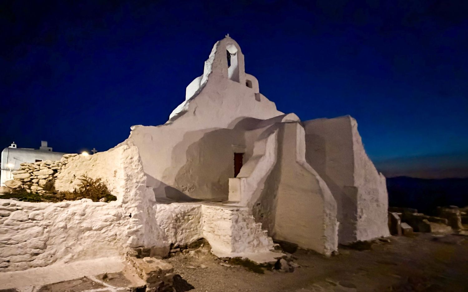 Church of Panagia Paraportiani illuminated at night in Mykonos Town, Greece