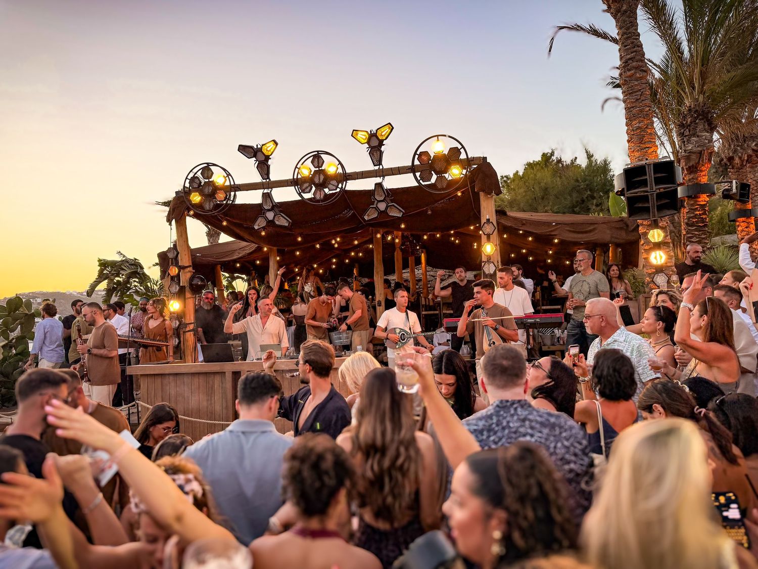 Crowd enjoying a live DJ performance at Scorpios Mykonos in Greece