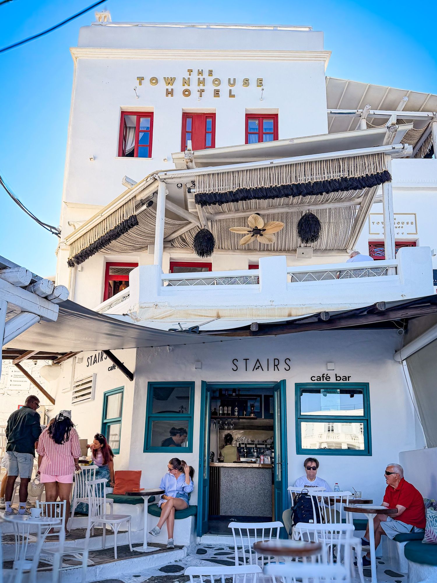Whitewashed storefront facing the Old Port in Mykonos Town, Greece
