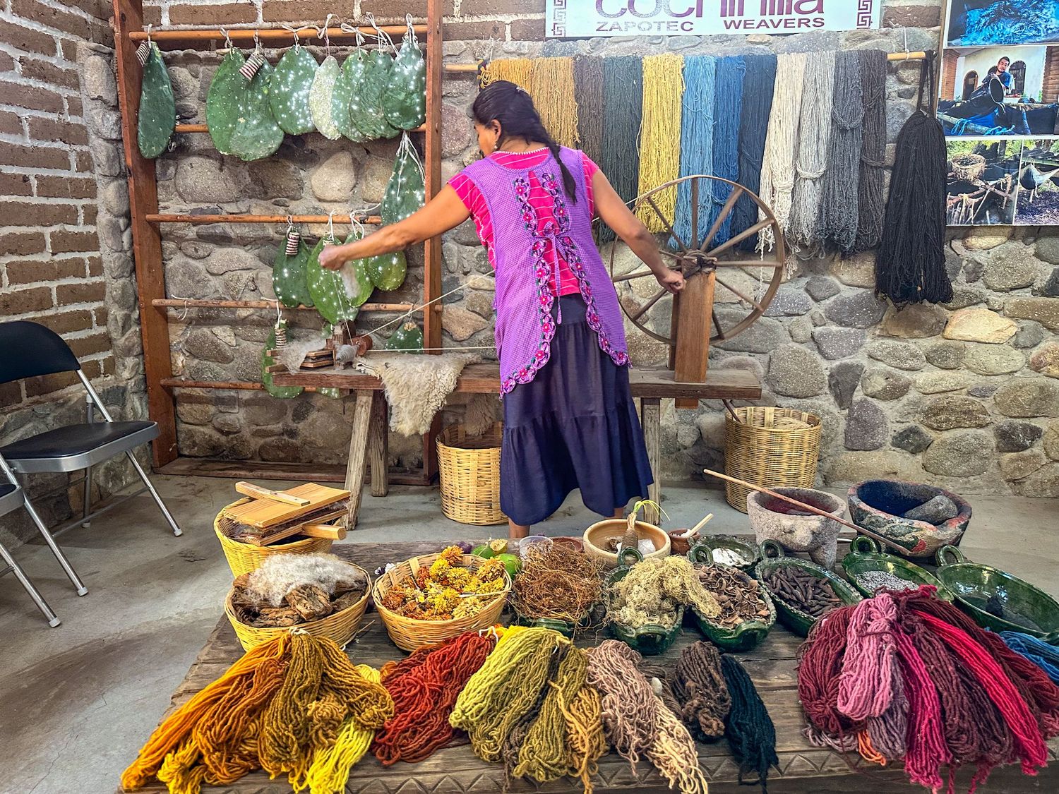 Oaxacan woman weaving wool at El Tono de la Cochinilla in Teotitlán del Valle, Mexico