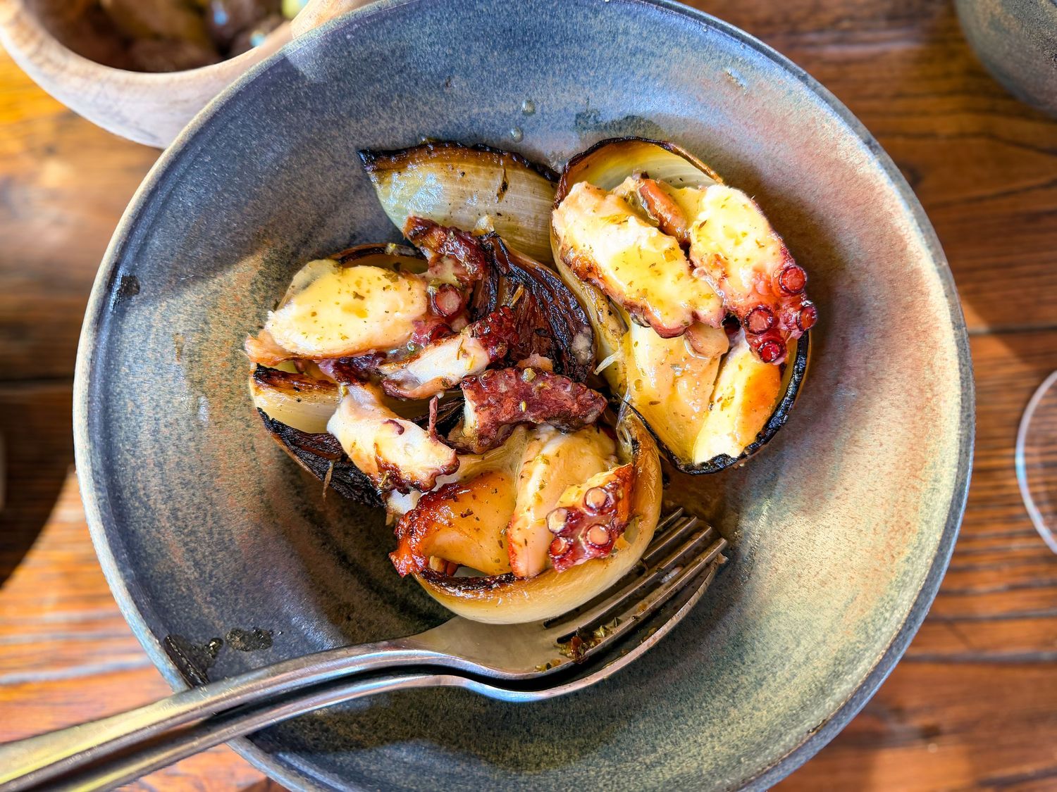Barbequed octopus with charred onions at Scorpios Mykonos in Greece