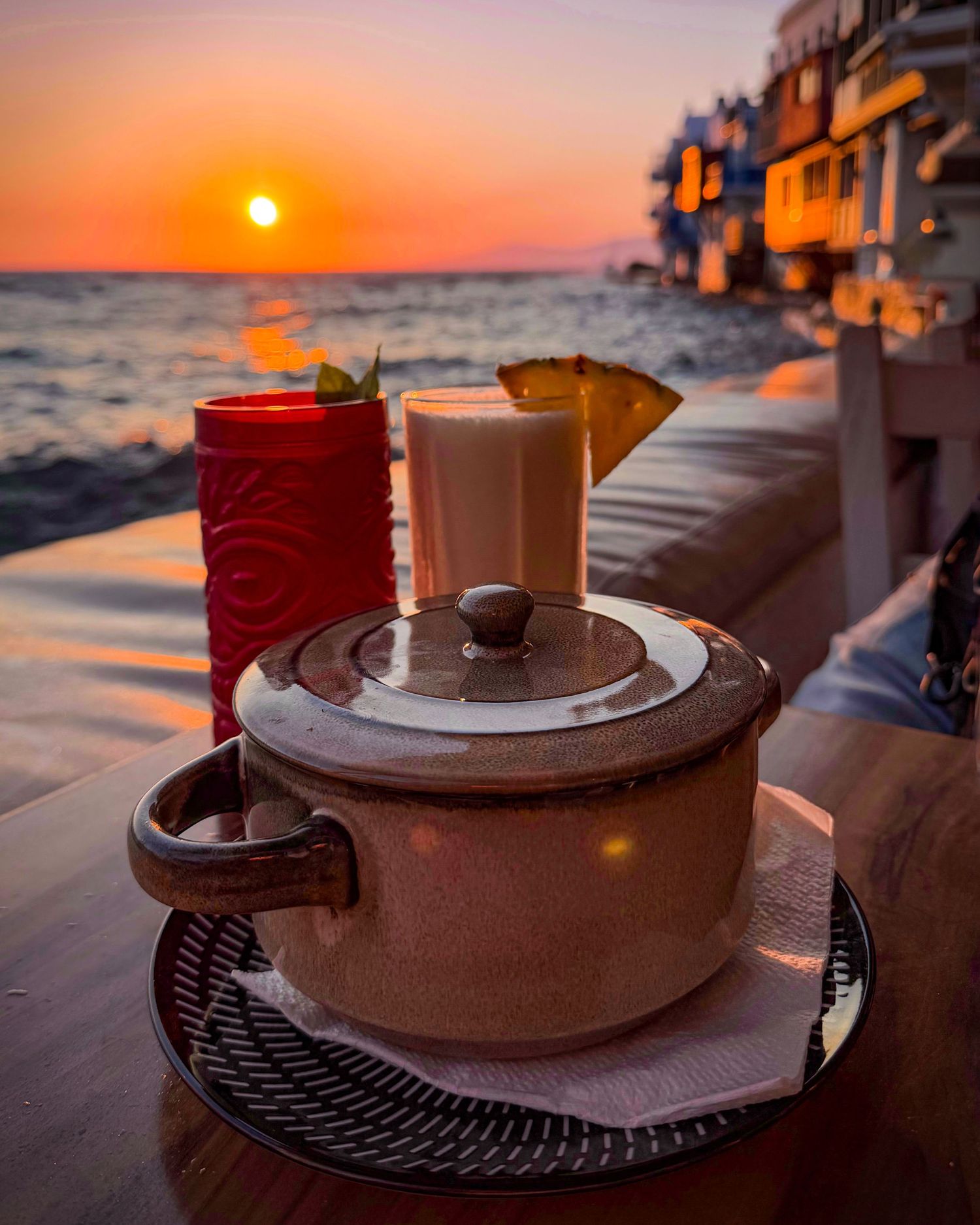 Moussaka and drinks overlooking Little Venice at sunset in Mykonos Town, Greece