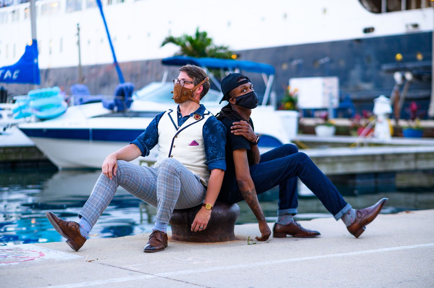 Tim and a friend wearing face masks at DuSable Harbor in Chicago, Illinois, with sailboats in the background