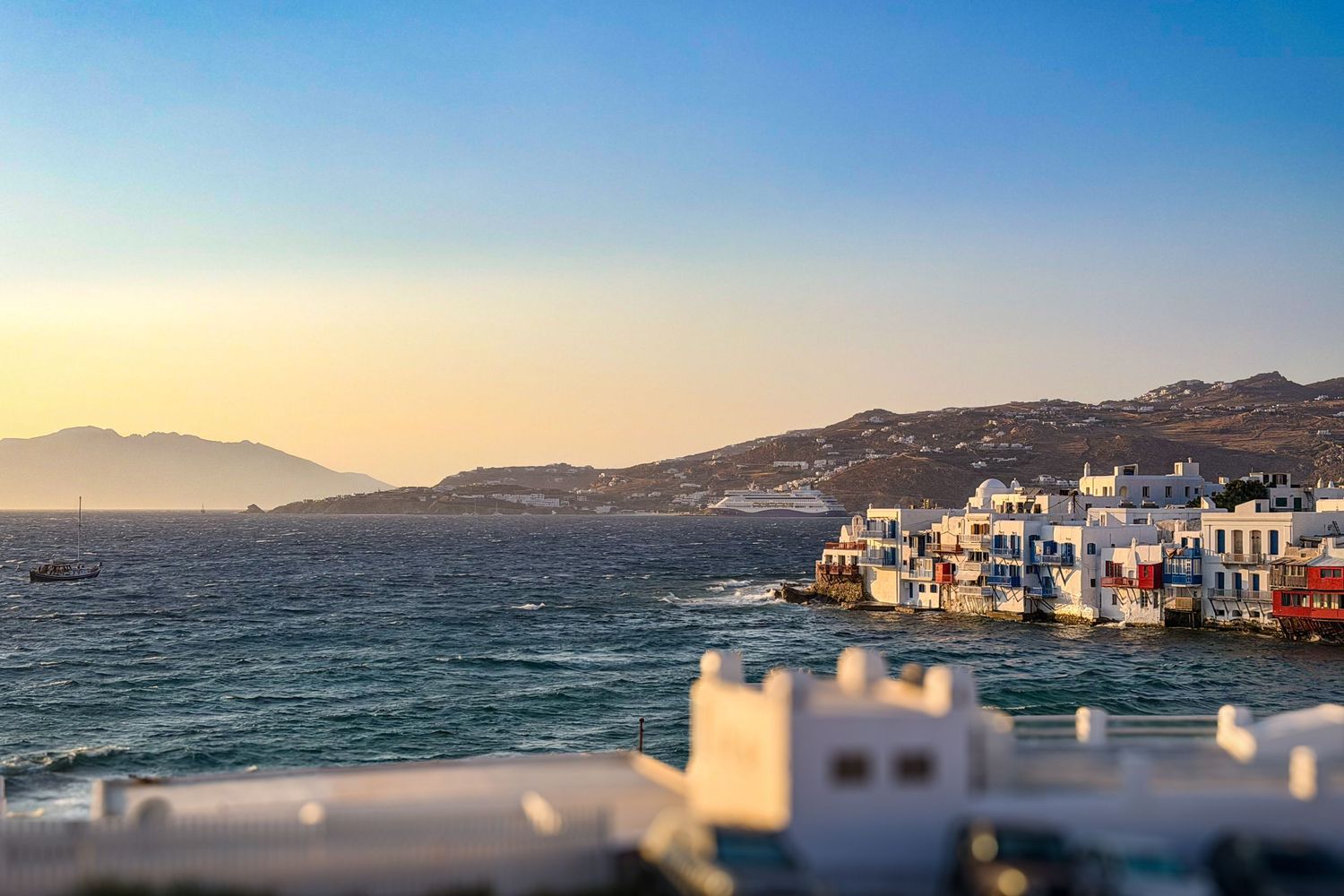 Sunset over the Aegean Sea, whitewashed buildings, and Little Venice in Mykonos, Greece