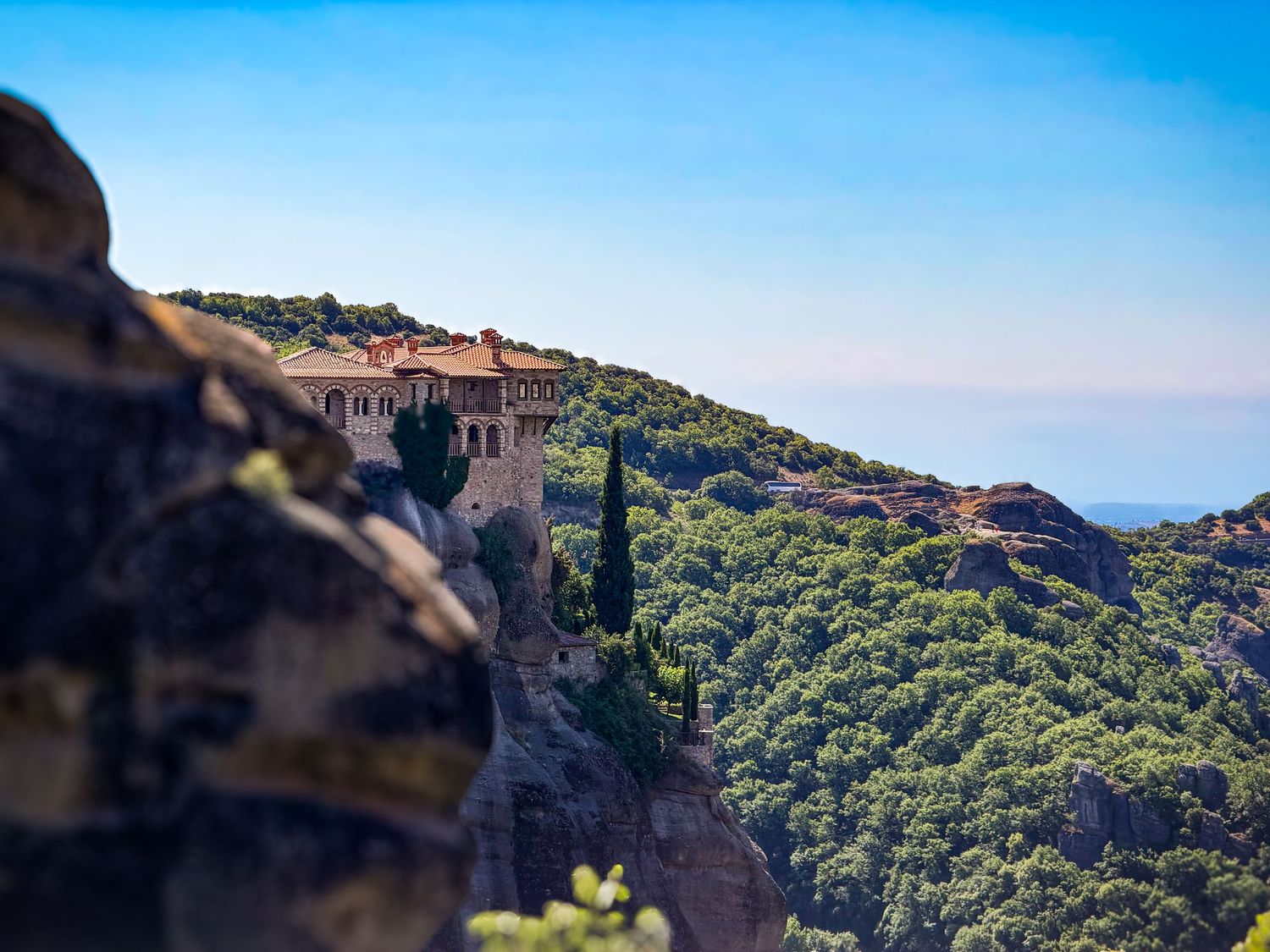 Monastery atop a rock pinnacle in Meteora overlooking the Thessalian plain in Greece