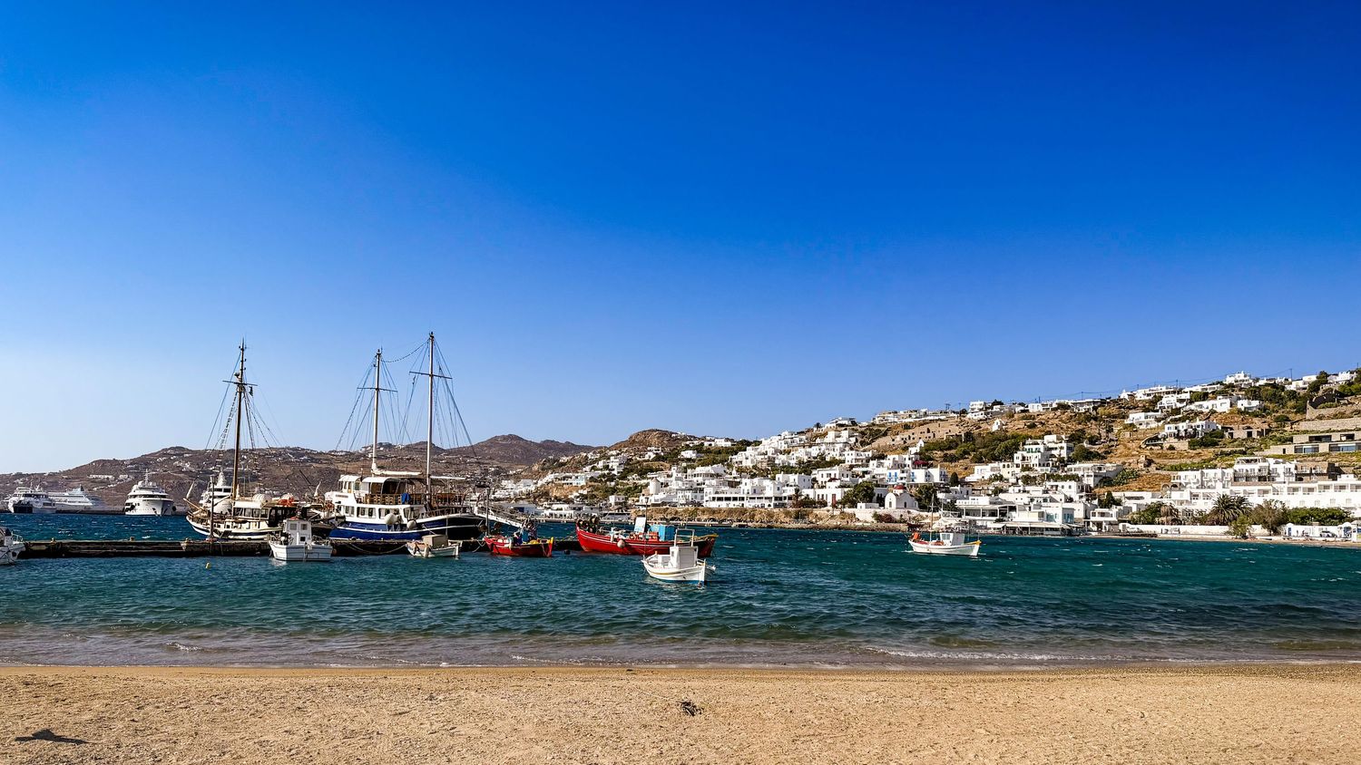 Whitewashed buildings and sailboats along the Little Venice waterfront in Mykonos Town, Greece