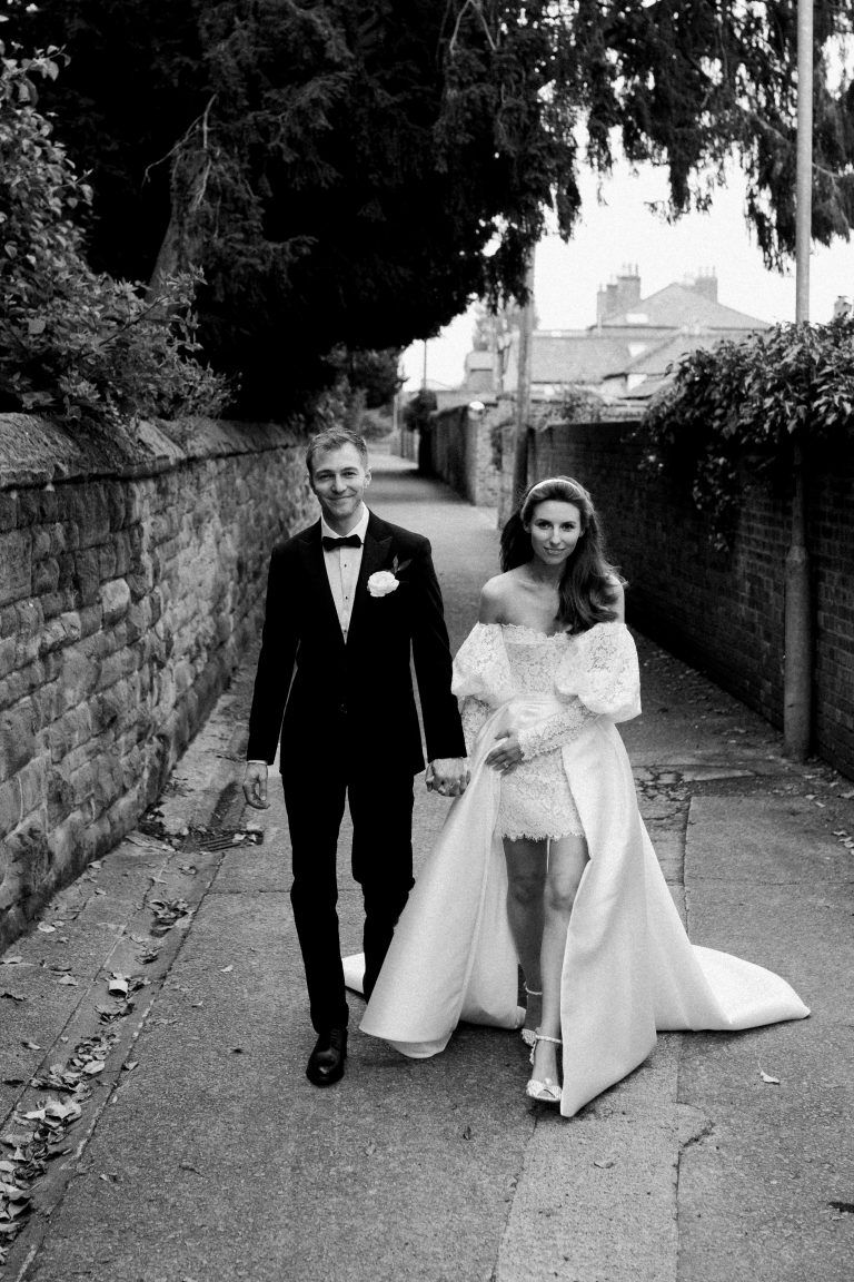 Bride and groom walking through Chester at their wedding