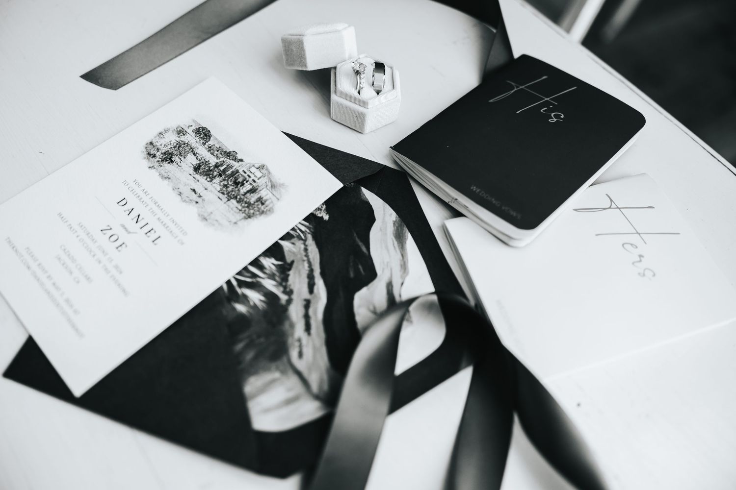 Black and white detail shot of wedding invitations and paper goods.