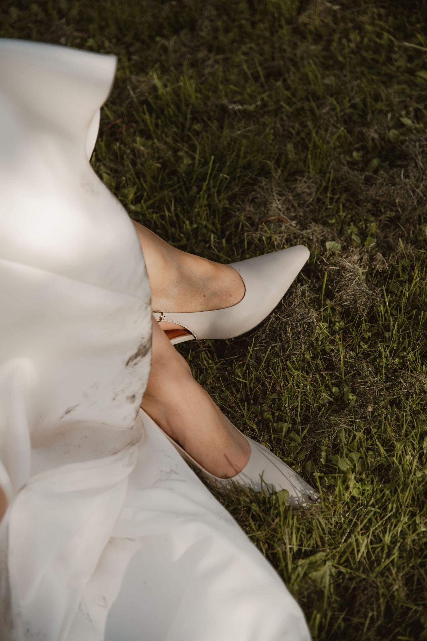 A sequence of images showing white wedding dress fabric and bare feet on grass in natural lighting.