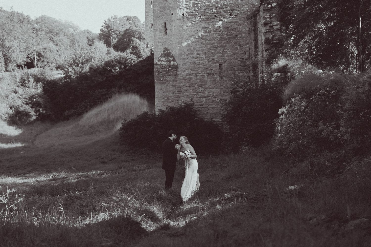 A series of five vintage black and white photographs showing moody garden pathways and stone walls.