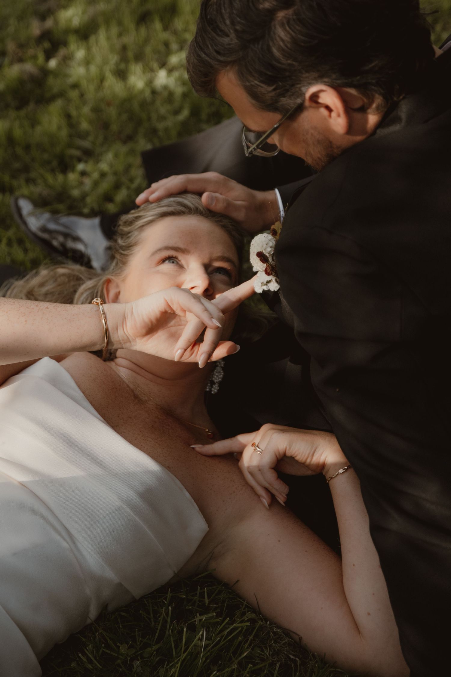 Intimate wedding couple shares tender moments in a series of romantic outdoor portraits in natural lighting.