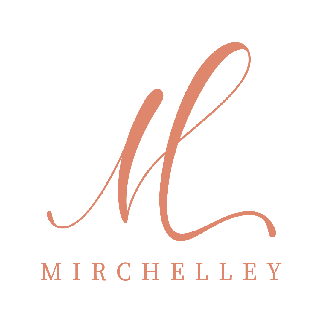 Mirchelley elegant script logo with coral pink cursive monogram and serif brand name on white background.