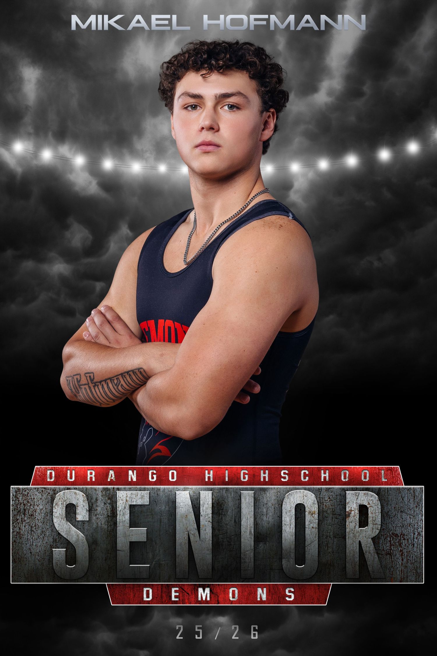 High school senior athlete poses in navy blue sports uniform against dramatic lighting with Durango Demons team branding.