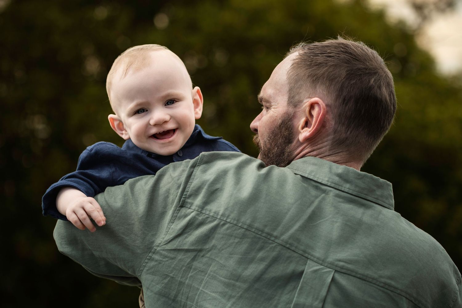 Melbourne cake smash photographer - Father and son playing peek a bo with the camera in Blind Bight Victoria