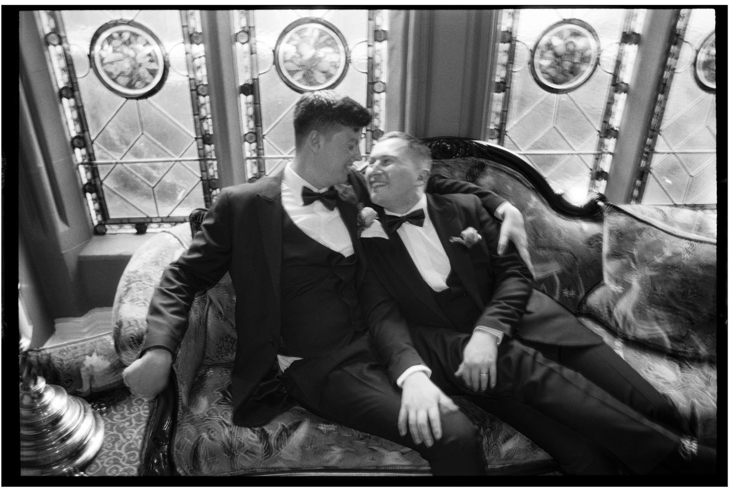 Black and white images of a couple sharing intimate moments in a vintage-style setting.