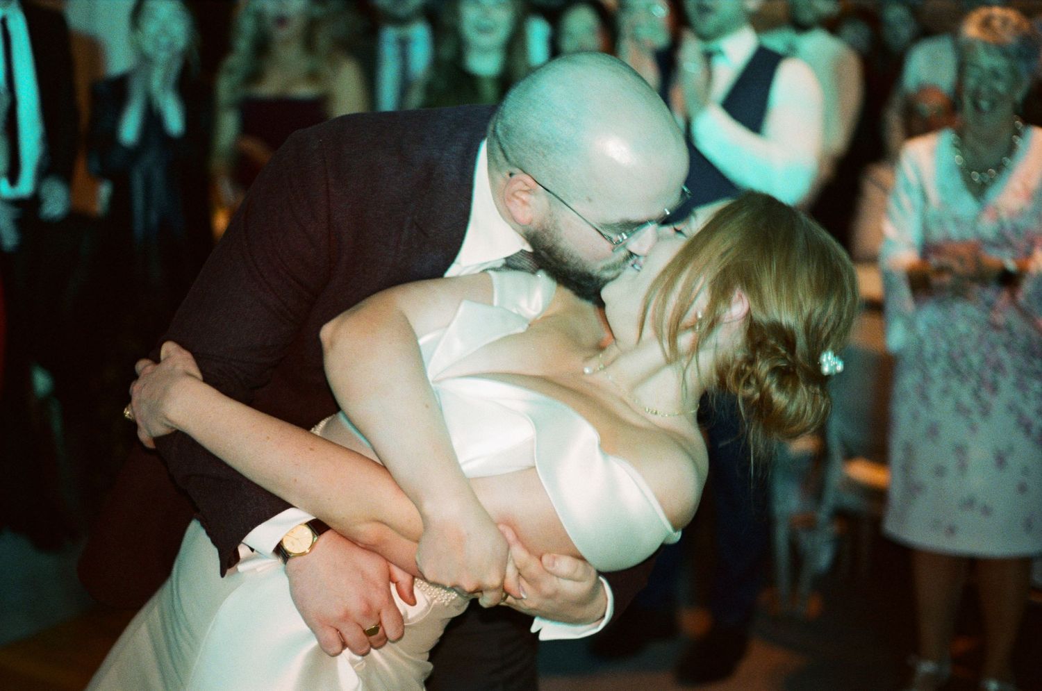 Couples dancing together at a wedding reception with romantic lighting and festive atmosphere.