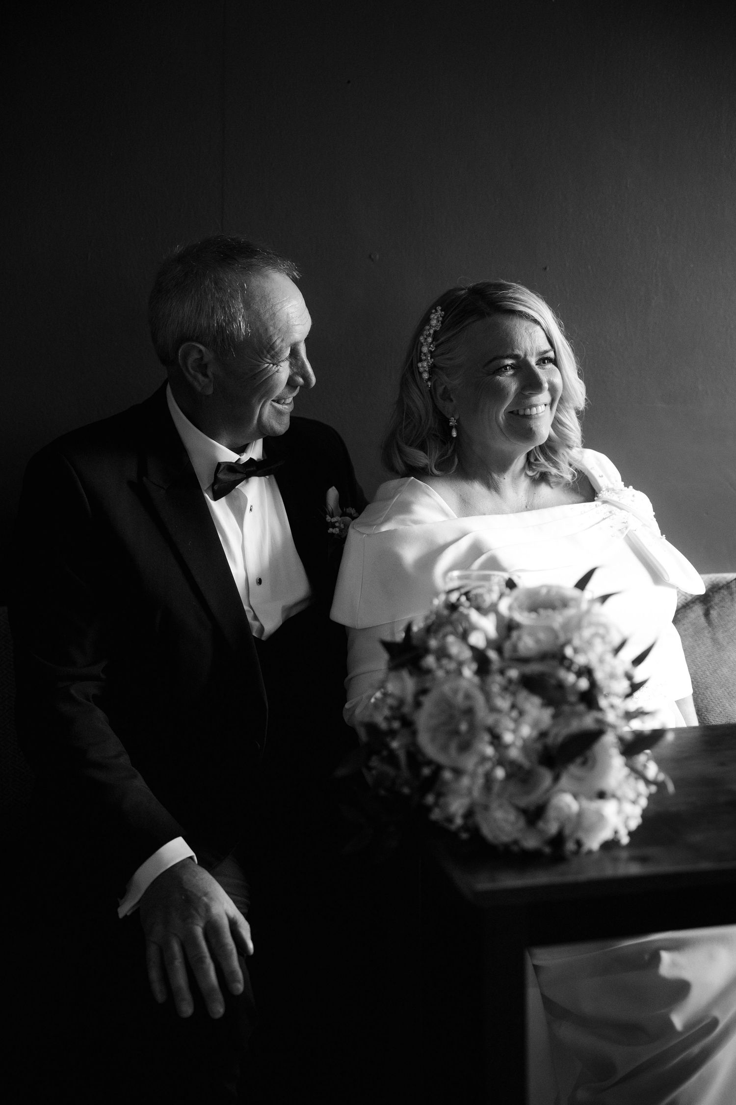 Black and white photo sequence showing a tender moment between two people with a bouquet of flowers in a dramatic lighting.