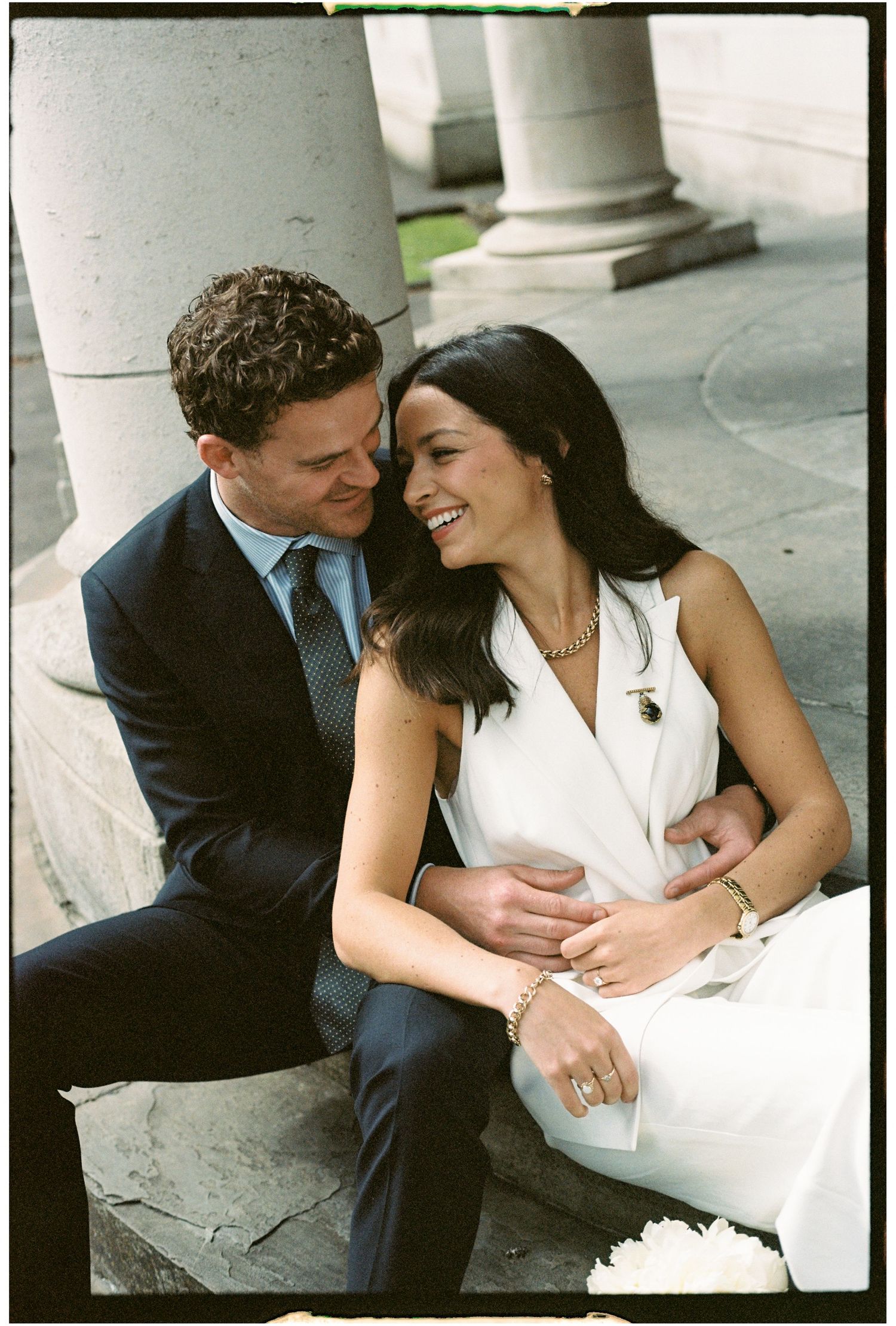A romantic couple in formal attire share intimate moments in a series of black and white engagement photos.
