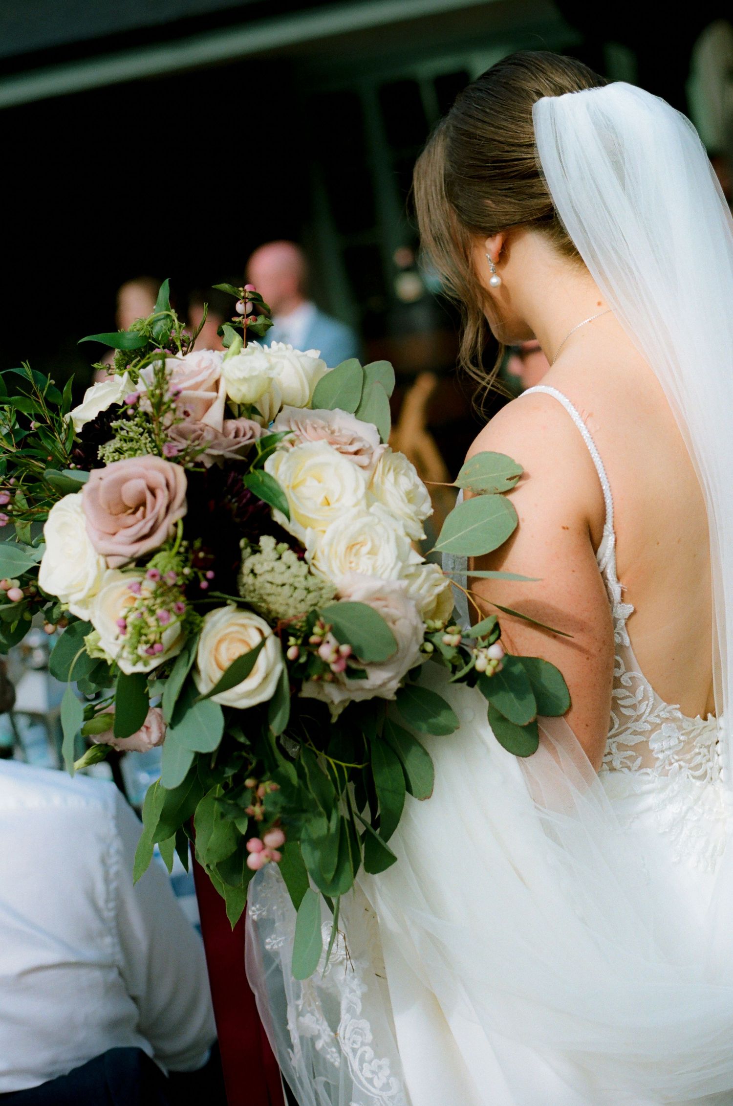 Elegant bridal bouquet featuring pink and white roses with eucalyptus greenery.