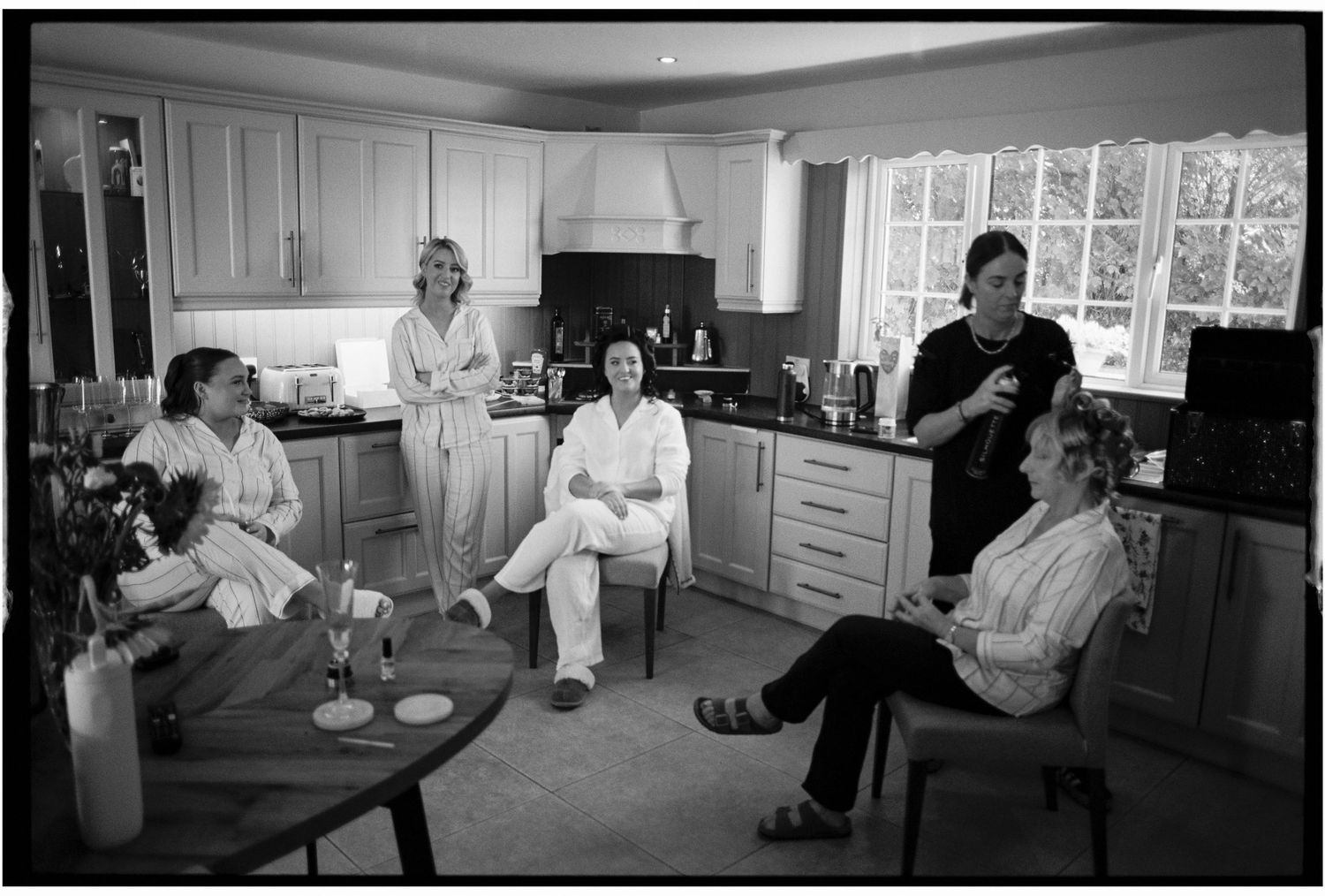 Medical professionals converse in a clinical setting while seated at tables and desks in a healthcare facility.