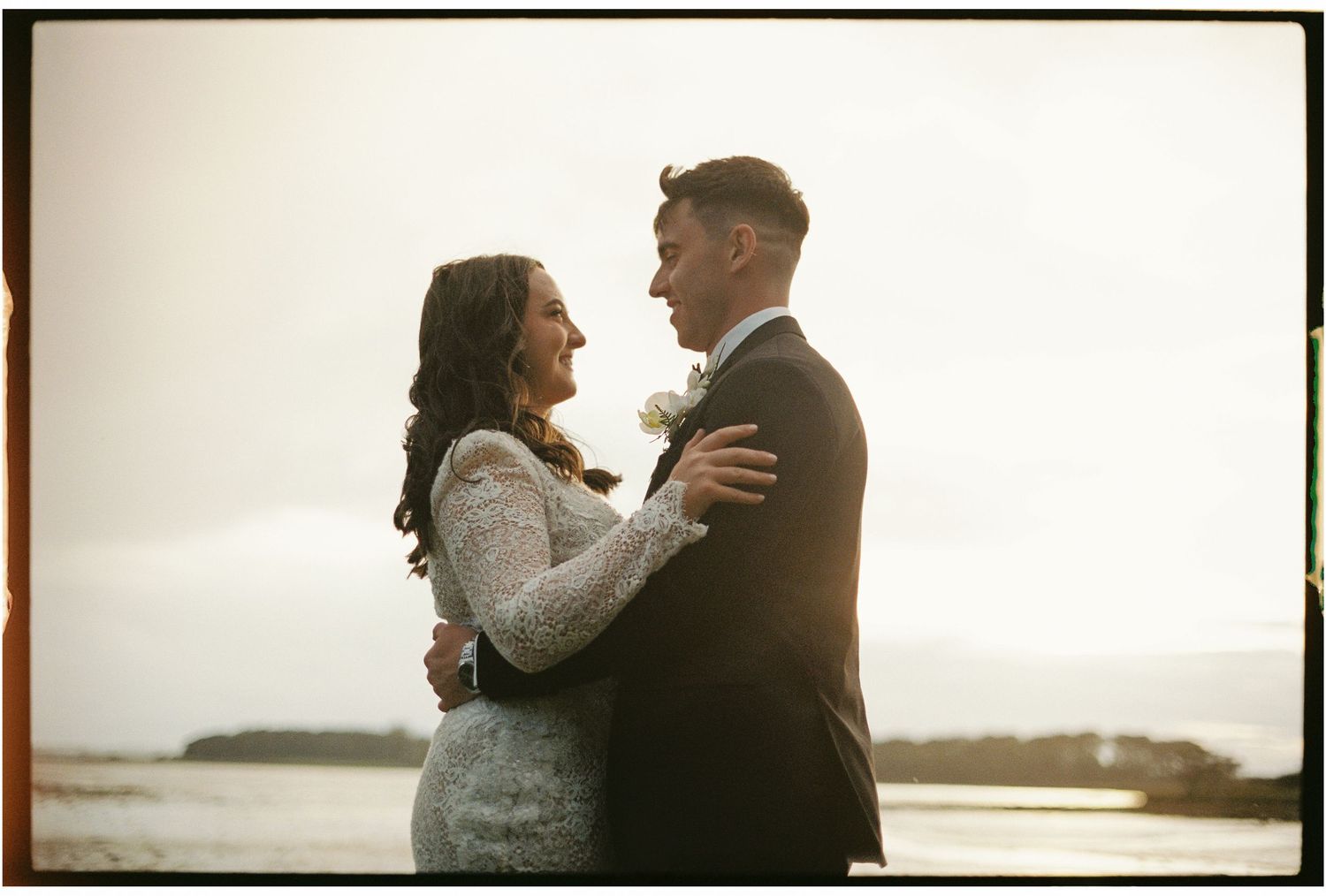 A romantic silhouette of a couple against a bright, hazy background.