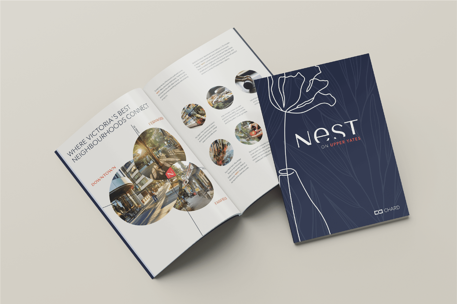 Open brochure beside navy hardcover booklet for Nest condominium development by Chard Properties.