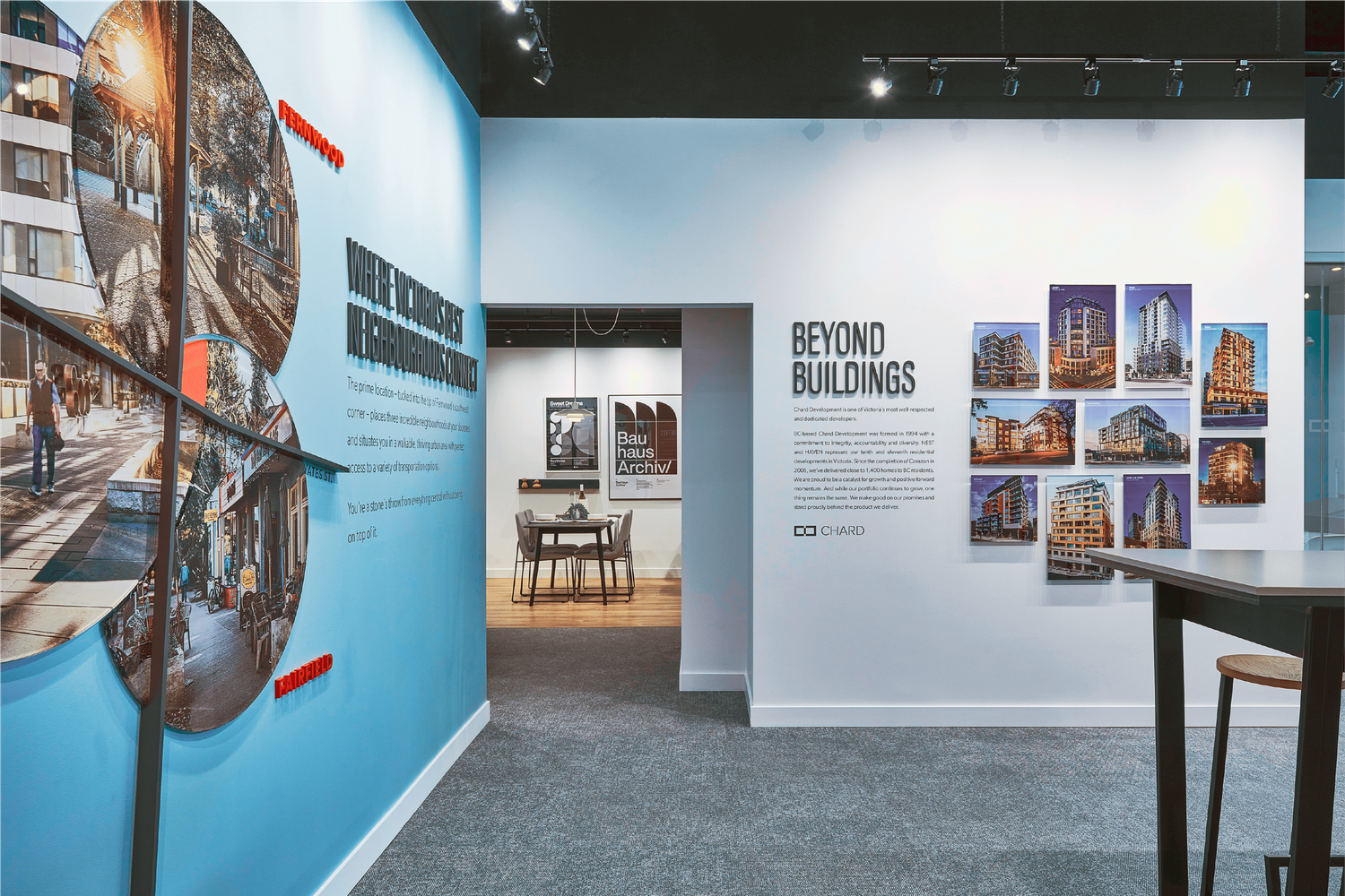 Nest on Upper Yates real estate sales center interior with blue accent walls featuring cityscape murals and Beyond Buildings display.