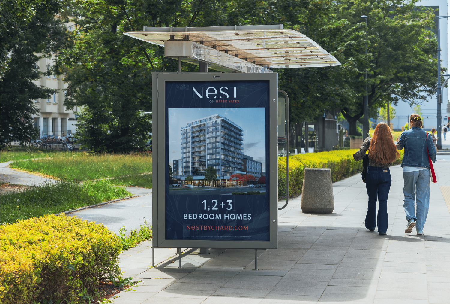 Bus shelter advertisement for Nest condominiums in an urban setting.