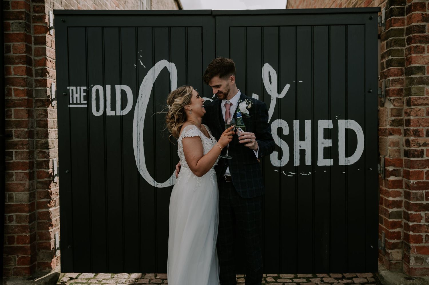 Hands being held together in close-up at an intimate wedding ceremony at The Old Shed venue.