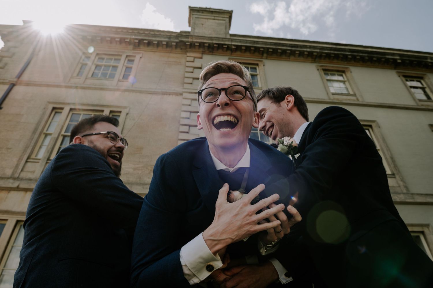 Four images showing people wearing business attire interacting and gesturing during what appears to be an outdoor meeting.