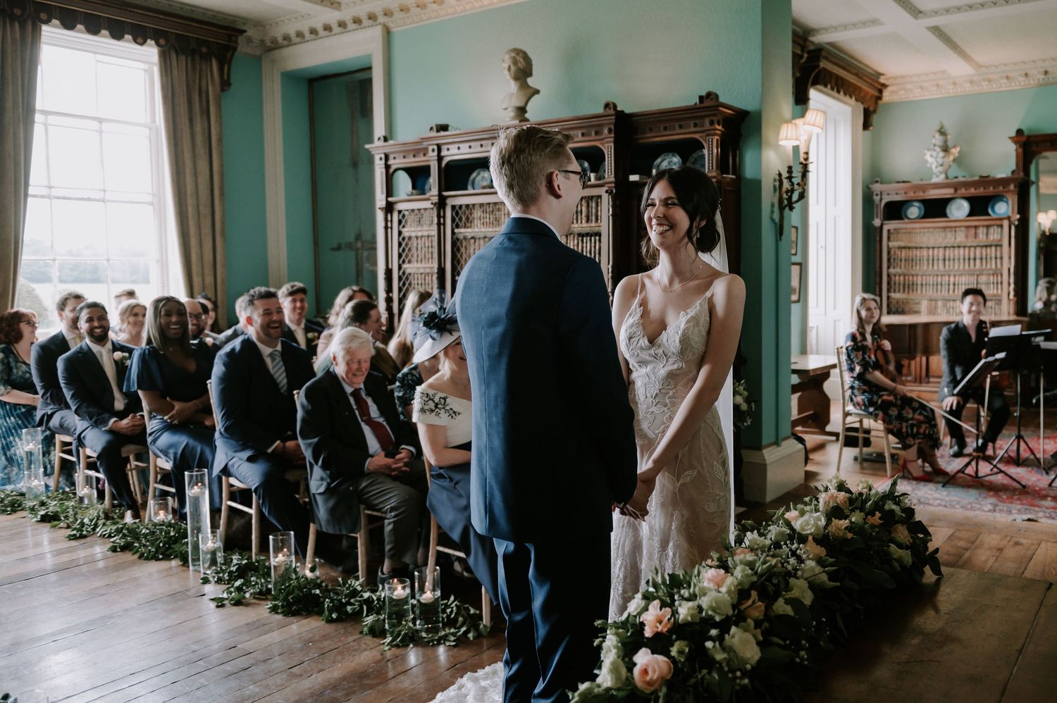 A sequence of wedding ceremony moments showing guests, decor, and a couple exchanging vows in a vintage indoor venue.