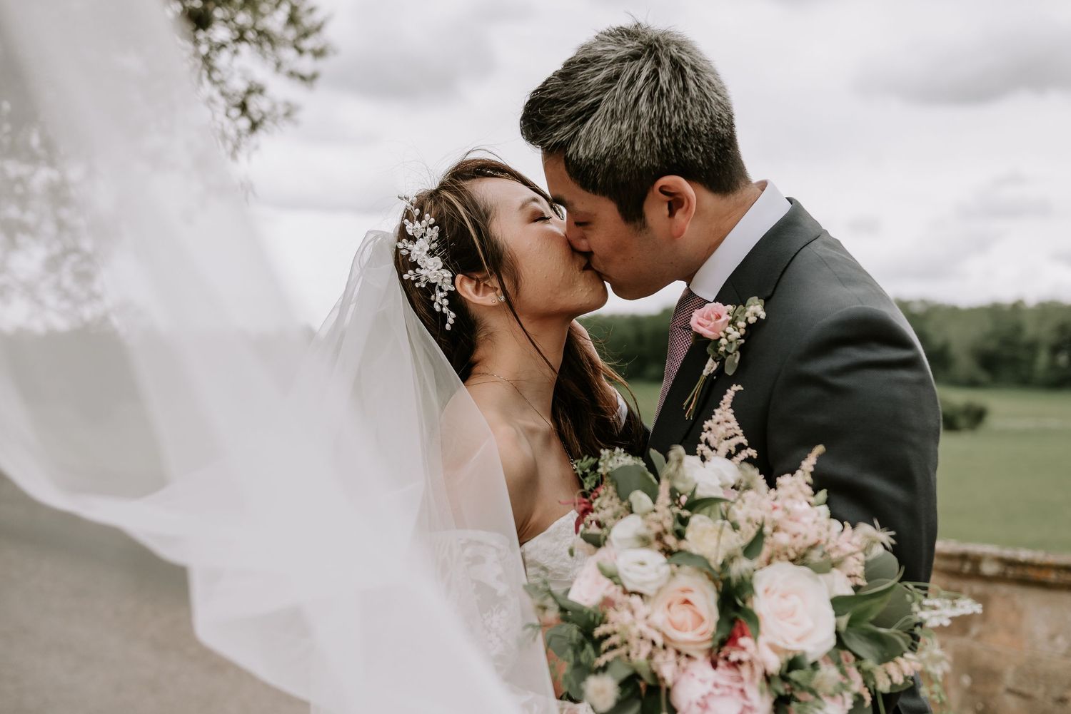 A romantic wedding photography series showing intimate moments between newlyweds with soft pink florals.