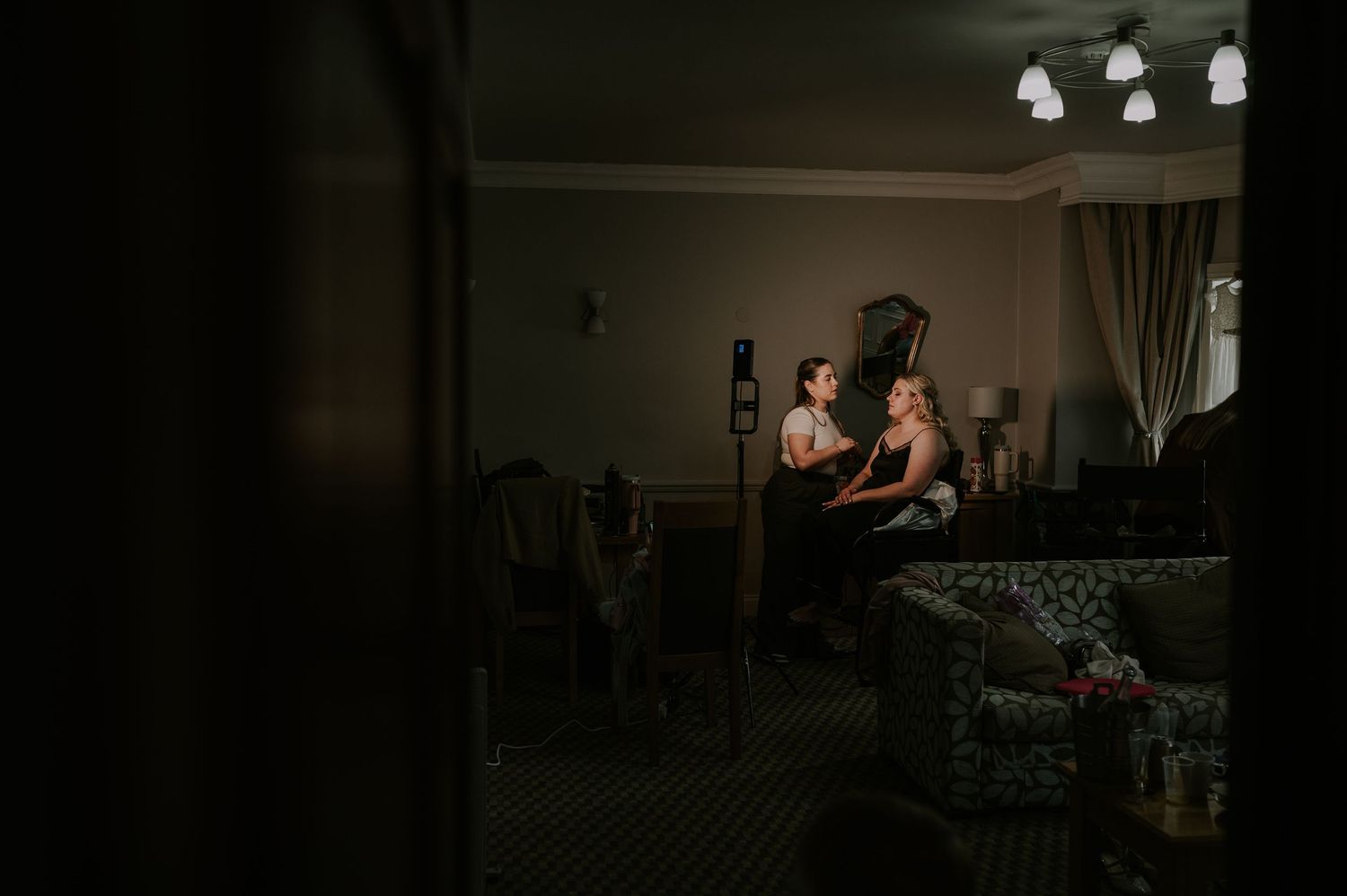 Dark nighttime movie still shows someone in street illuminated by bright headlights in tense cinematic scene.