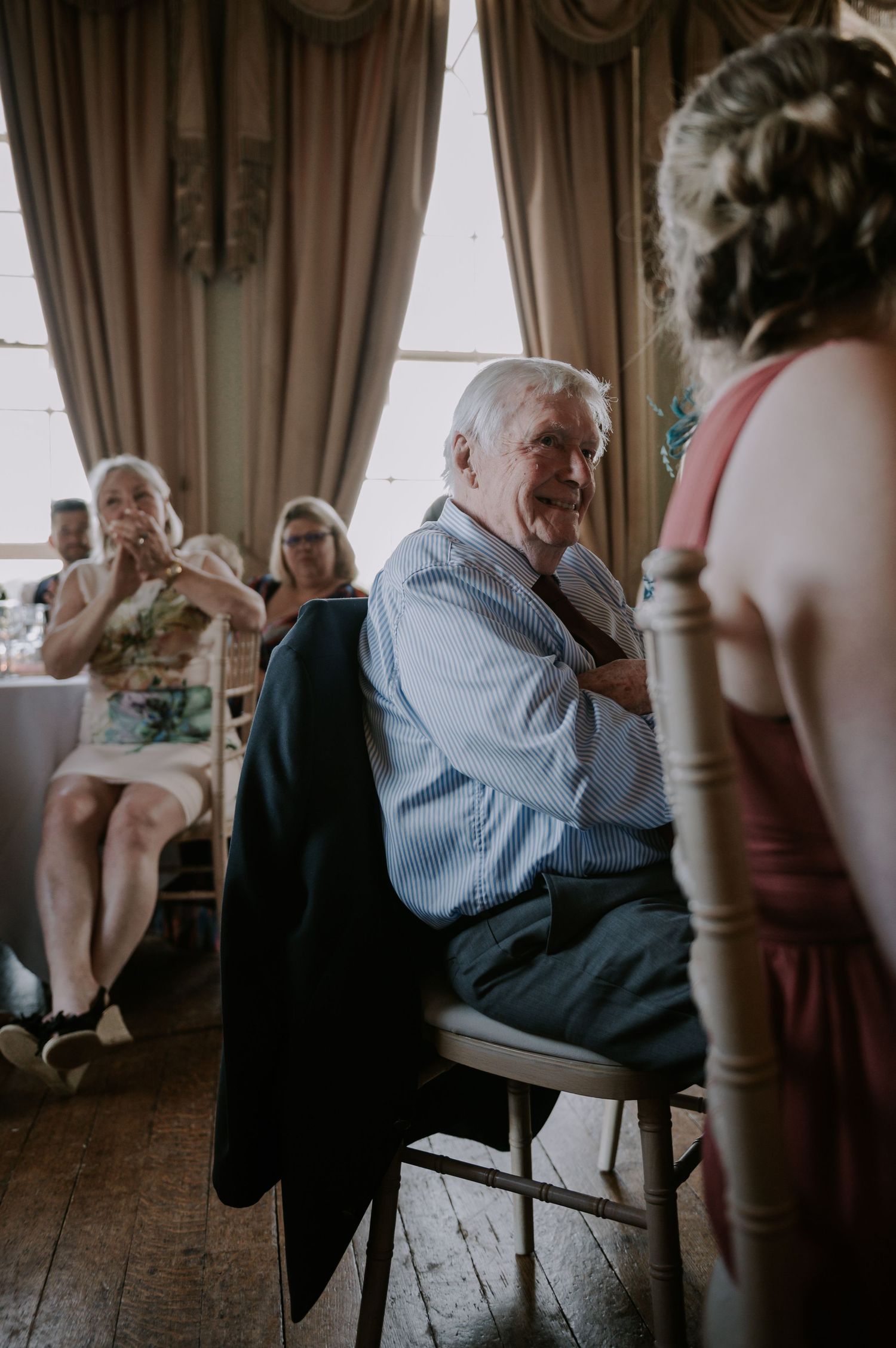 A sequence of images showing an elderly man in a blue shirt reacting emotionally during what appears to be a wedding reception.