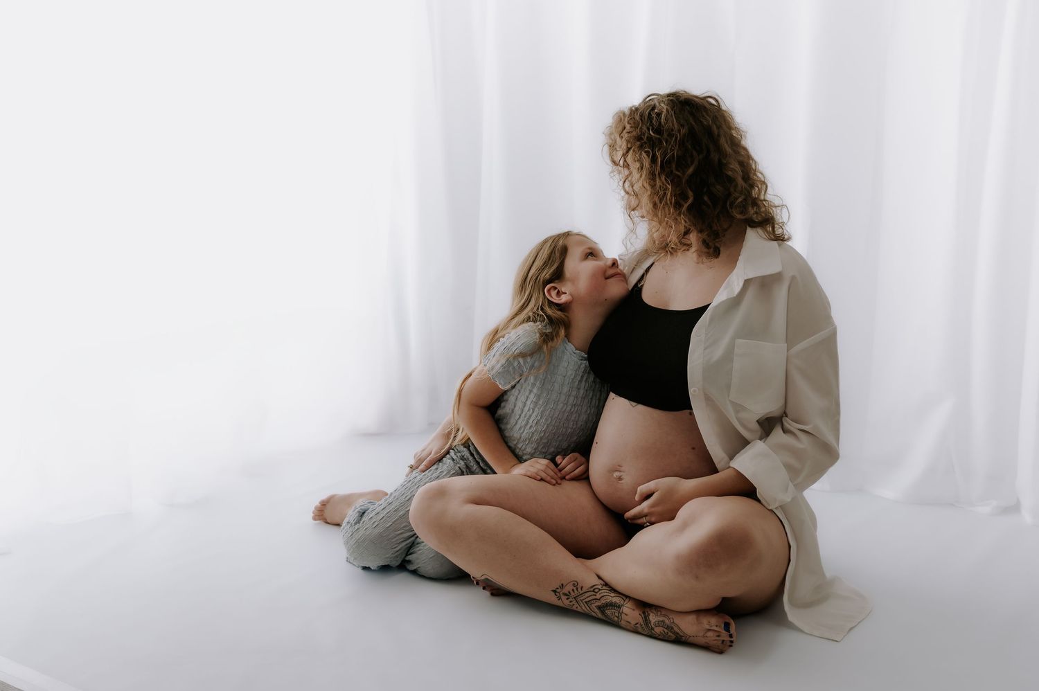 Mum and daughter laughing together, studio maternity session, Melton Mowbray.