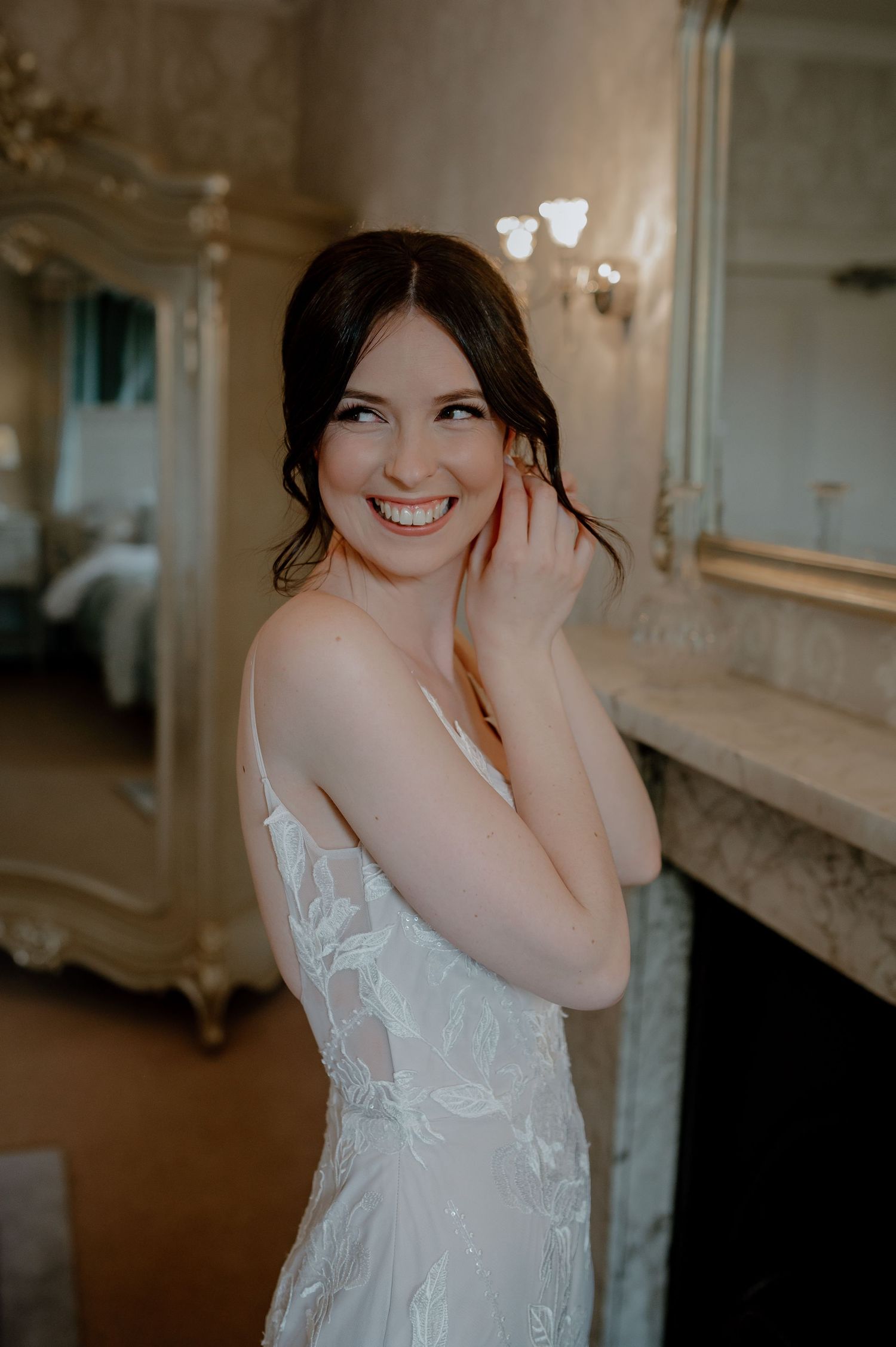 Elegant bridal portrait series showing details of white lace wedding dress in a luxurious indoor setting with soft lighting.