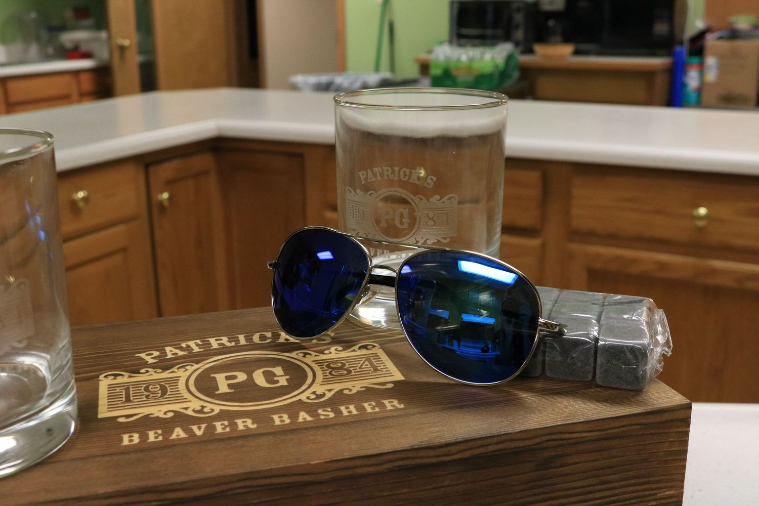 Groomsmen gifts of sunglasses, humidor, cigars, and drink cubes.