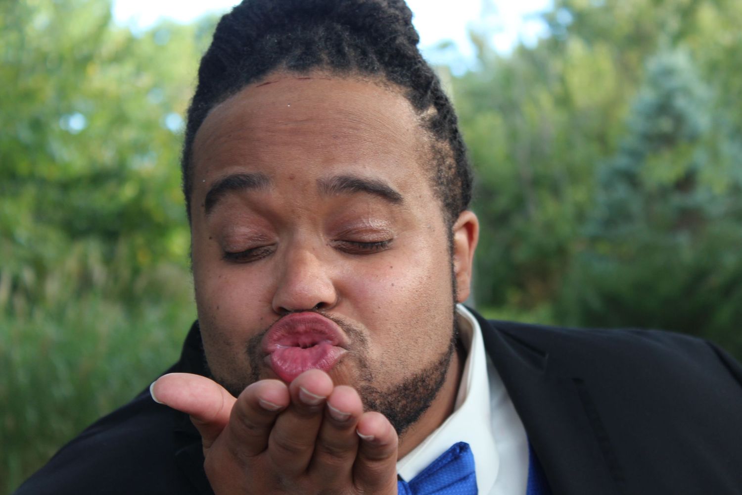 Groom blowing kisses to his future bride.