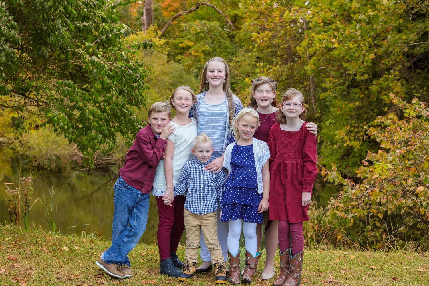 Cousins standing together and holding hands for fall session at Fort Harrison State Park in Indiana.
