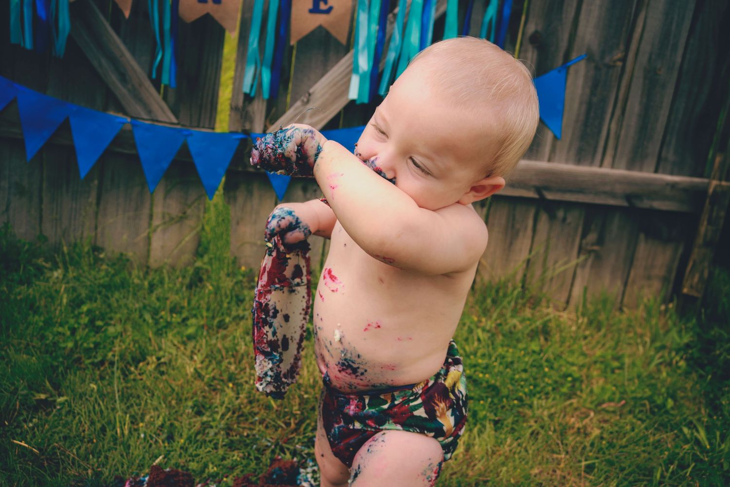 Smash cake was smashed and eaten by birthday boy turning one years old.