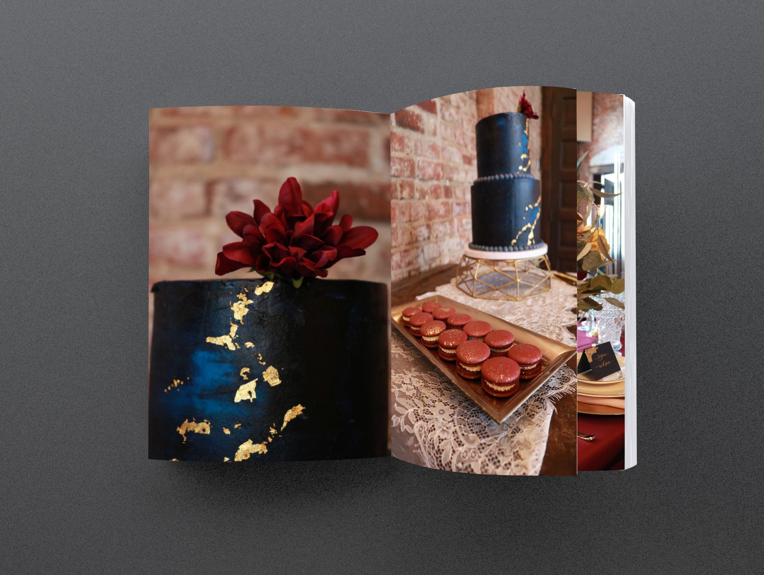 Elegant black cake with gold leaf and red flower beside a dessert table with macarons and dark tiered cake.