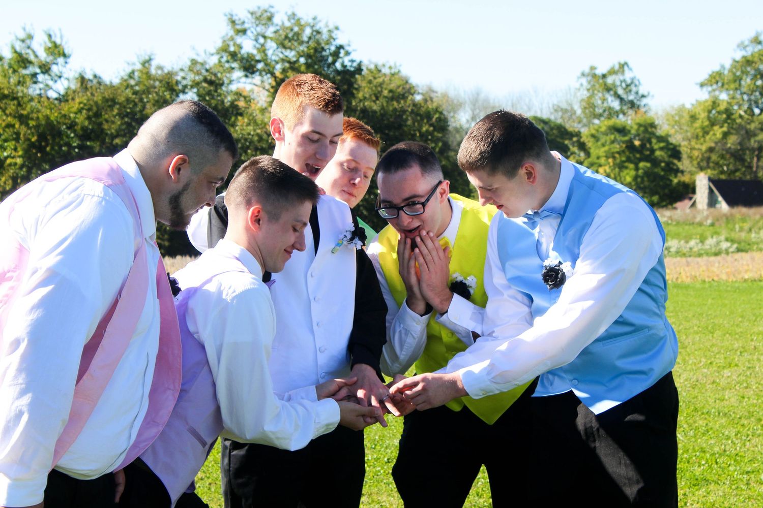 Groomsmen admiring groom's wedding ring.