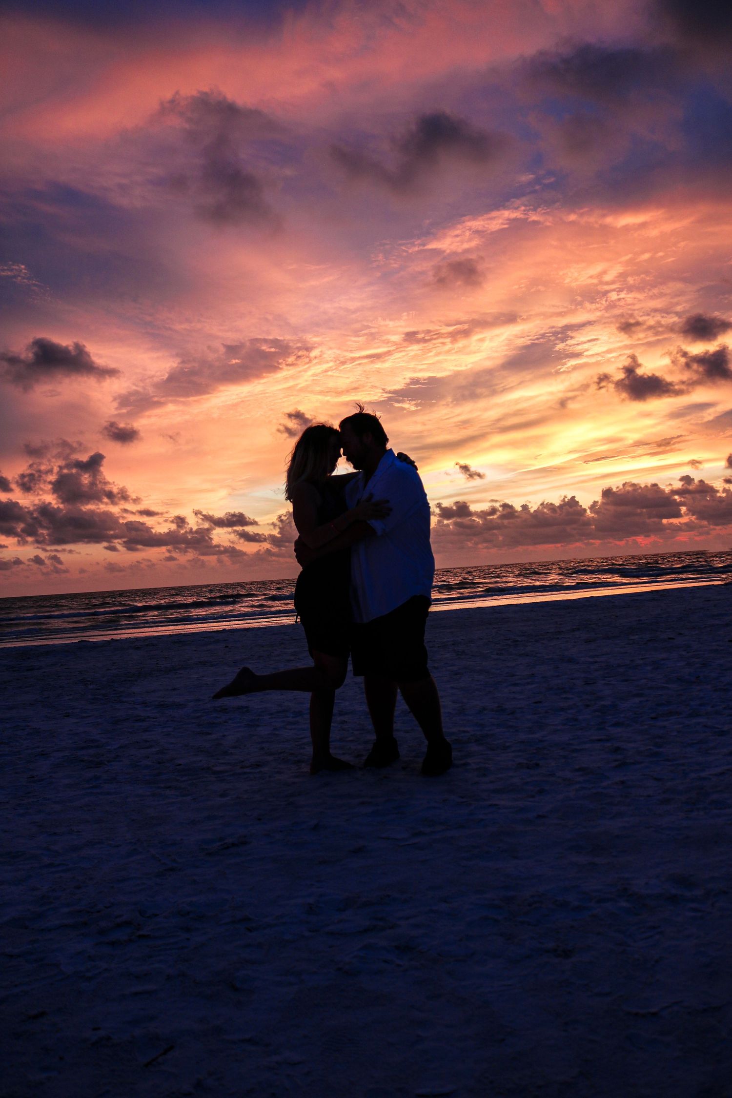 Sunset photography session of a husband and wife on the beach