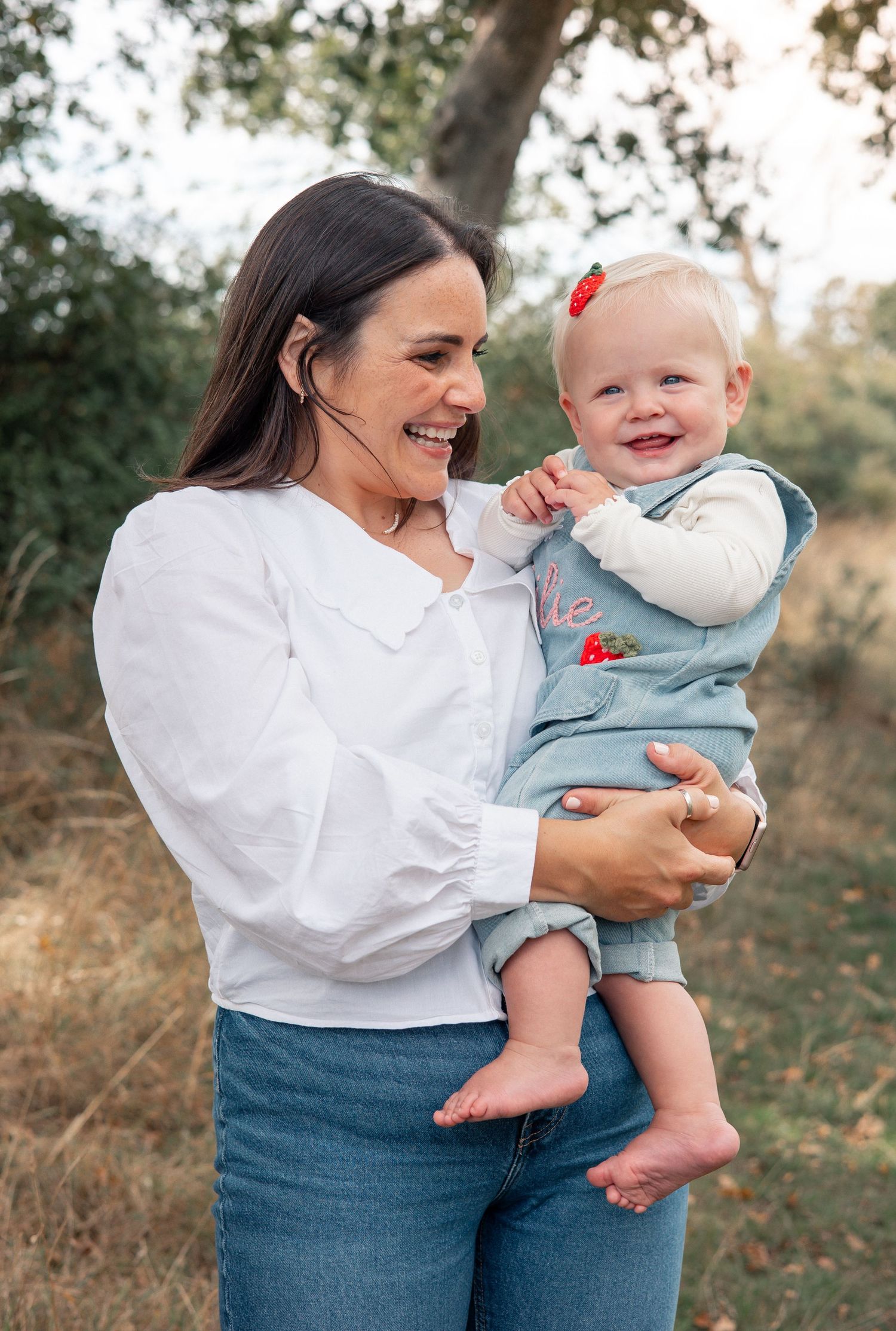 Candid, natural and joyful outdoor moment with mum and baby during milestone photoshoot. Bibury.