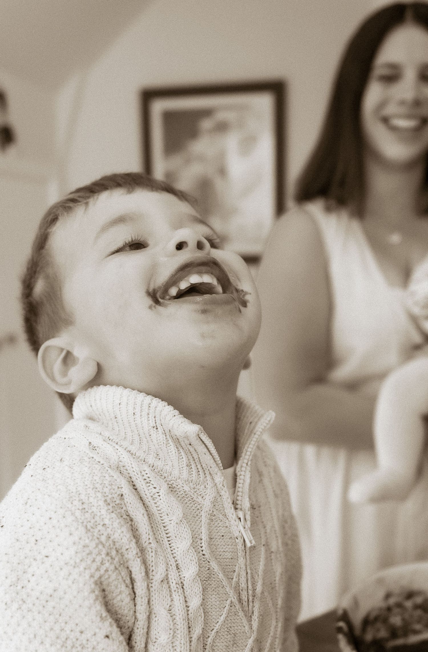 Storytelling Photoshoot of son smiling with cake around his lips in Lower Slaughter, Cotswolds.