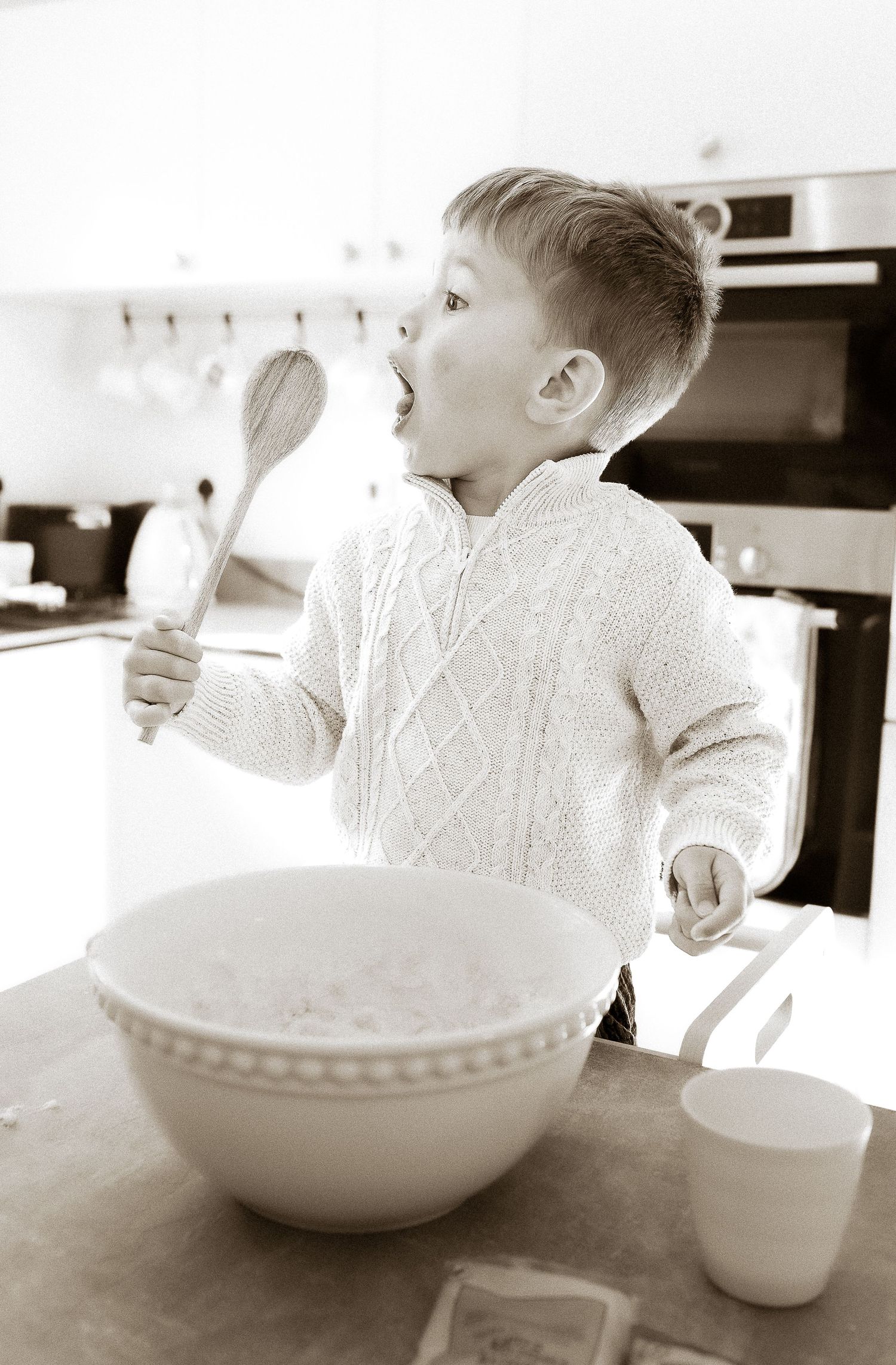 Storytelling Photoshoot of boy mixing ingredients in a white ceramic bowl in Tetbury, Cotswolds.
