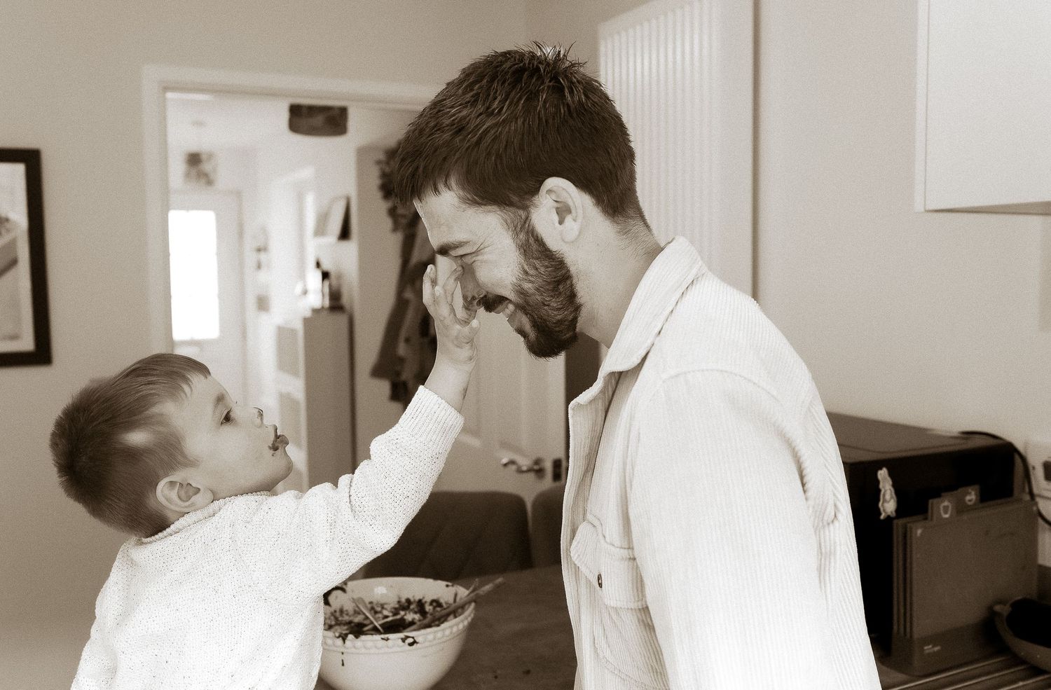 Storytelling photoshoot of dad and son making cakes at their home in Broadway, Cotswolds.