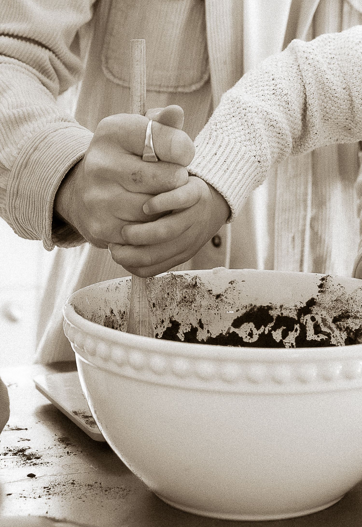 Storytelling Photoshoot of two people mixing ingredients in a white ceramic bowl in Tetbury, Cotswolds.