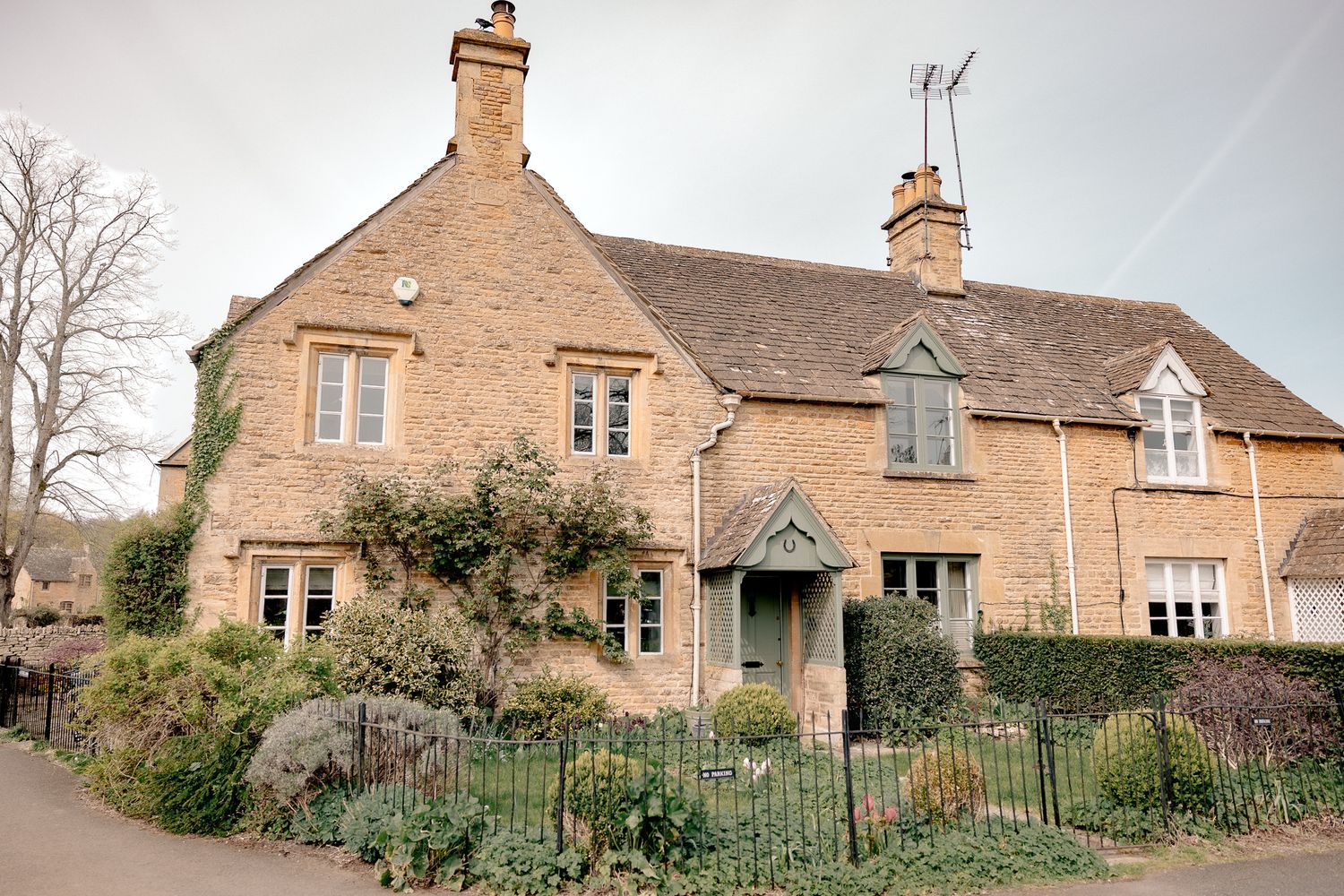 Charming Cotswold stone cottage with ivy-covered walls, in an English village, Lower Slaughter, Cotswolds, UK.